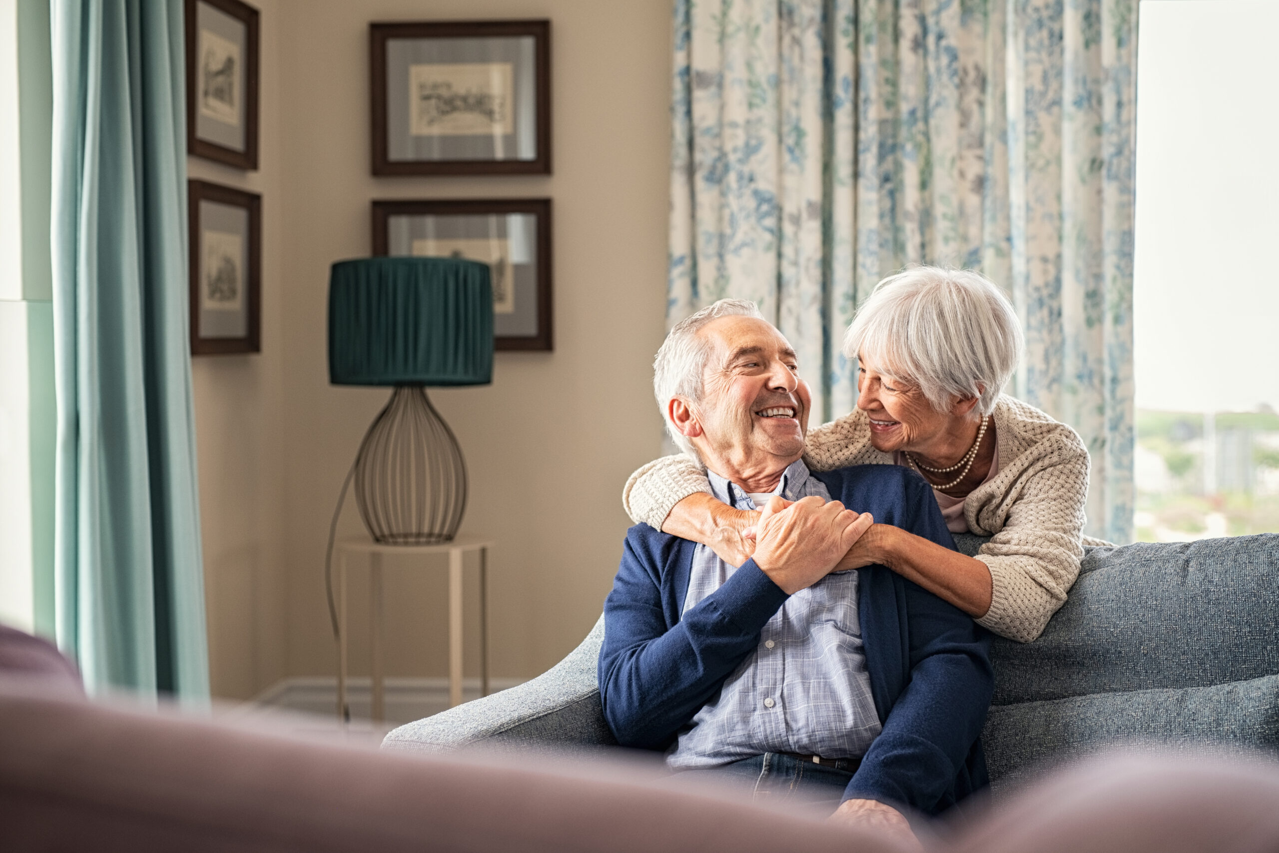 Senior couple smiling and enjoying each other's company together and illustrating how home and community based services can contribute to Americans preferring to live at home as they age.
